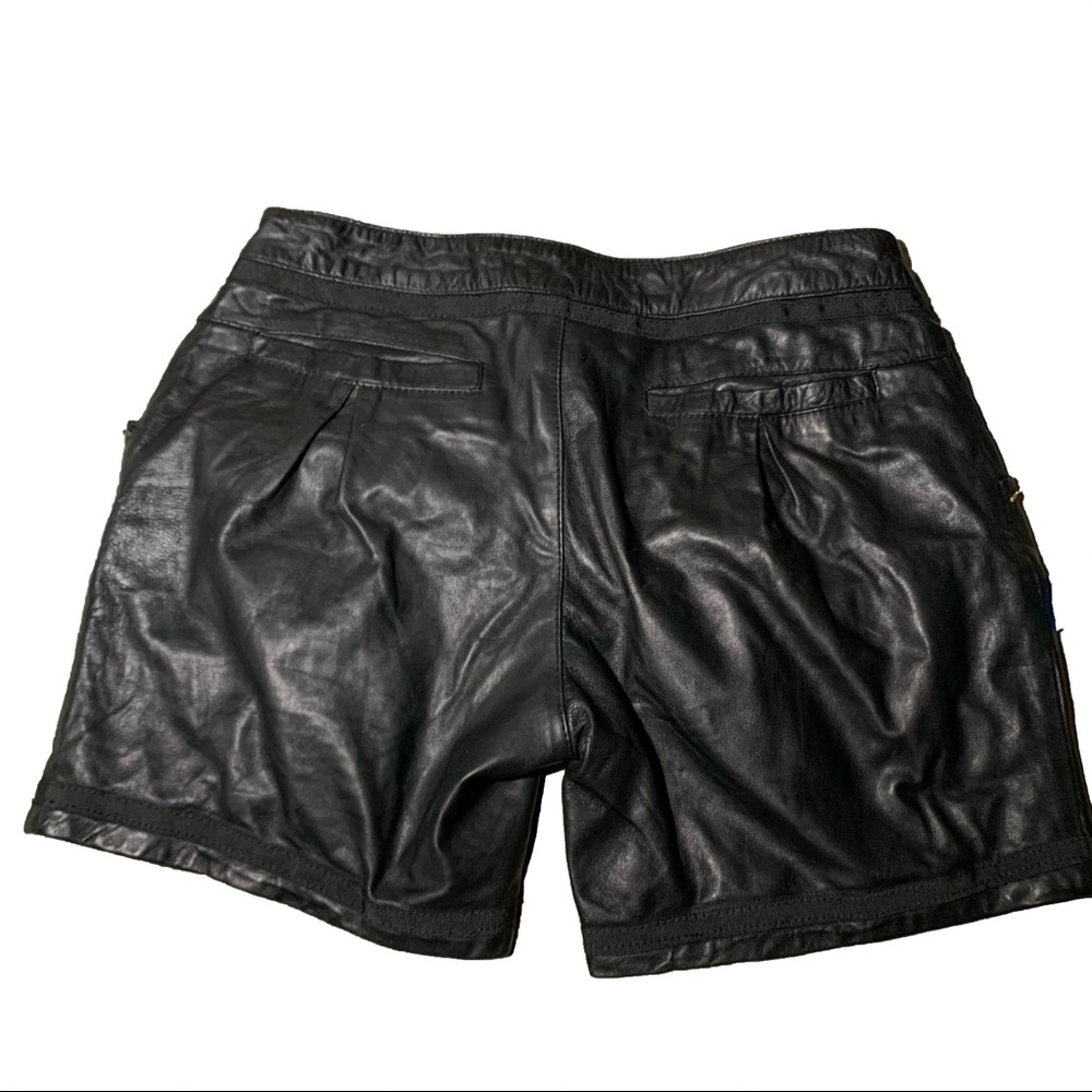 Leather biker shorts with gold metal details